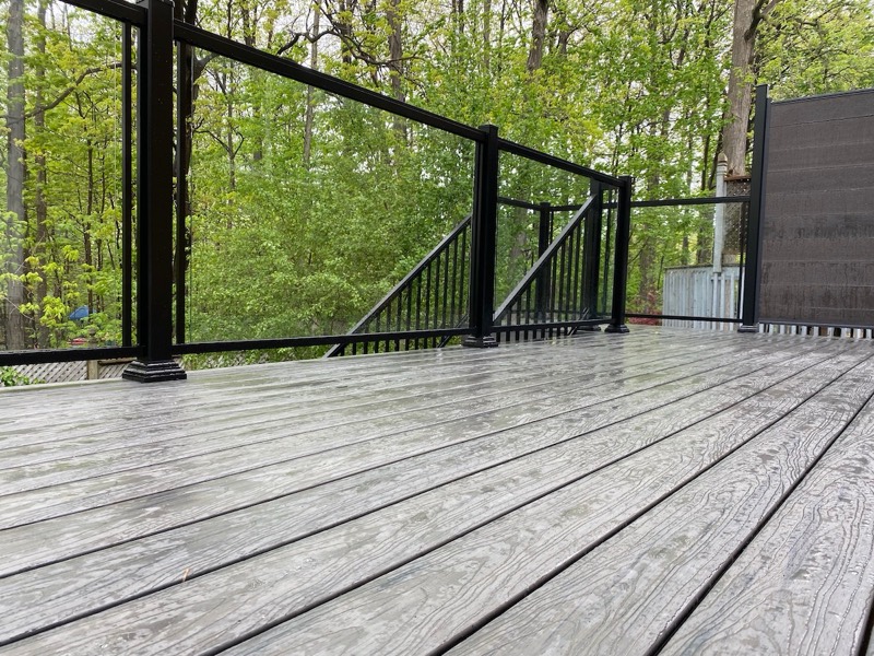 Grey composite deck with glass railing in Toronto